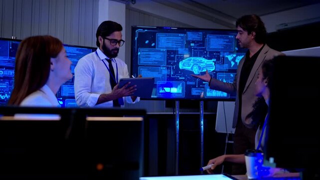 Multicultural business and engineering team discussing software development strategy and digital system planning in futuristic technology workspace