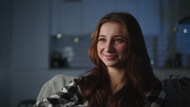 Happy Young Girl Switches Tv Channels With A Remote Control In An Evening Room. Close-Up Portrait