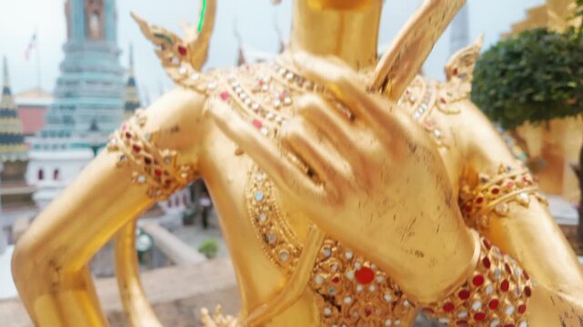 Golden Kinnaree statue at the Grand Palace, Bangkok, Thailand. This mythical creature, half-human and half-bird, is a symbol of beauty and grace in Thai culture.