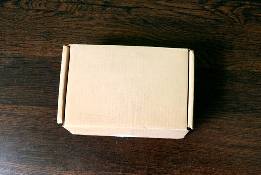 Blank Cardboard Shipping Box on Wooden Surface