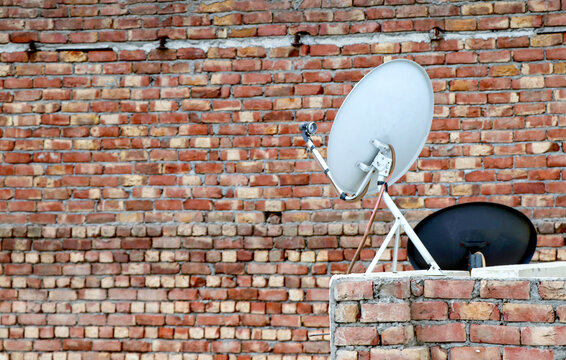 Satellite TV Dish Antenna Mounted on a Rooftop