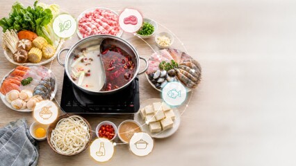 Hot pot party with assorted ingredients arranged on table, perfect for Asian cuisine background © dvoevnore