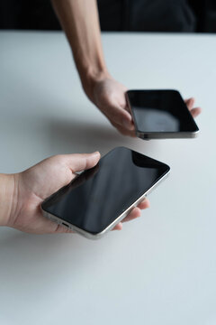 Man using smartphone close contect transfer file by wireless technology