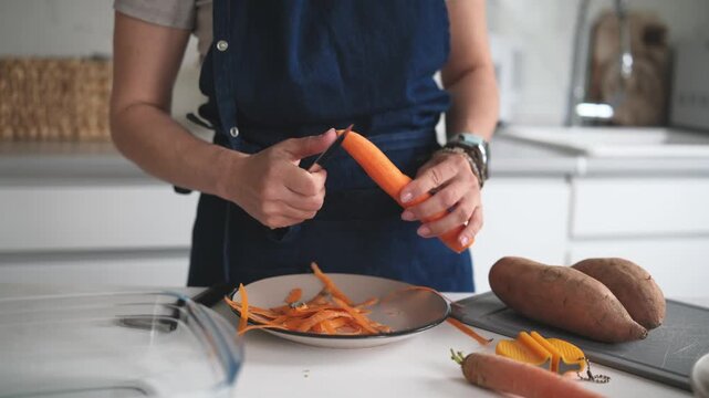 Close-Up Of A Woman Cleaning A Carrot
