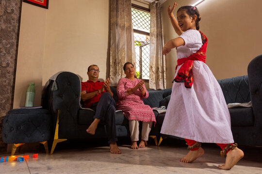 parent proudly watching their daughter's performance