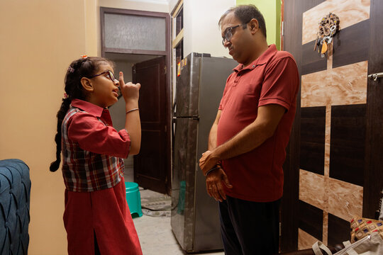 Father and daughter having a serious conversation at home