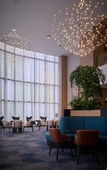 Fotobehang Hotel chique Luxury hotel lobby with modern chandeliers and lounge seating  © BH