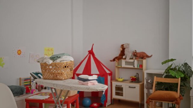 Nursery room with soft defocused bokeh background interior showing laundry basket and play tent softly blurred; background backdrop copyspace calm.