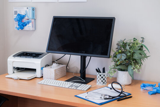 Workstation in a healthcare office with medical supplies on a desk