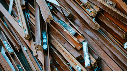 Obraz premium Pile of discarded brown wooden baseboards and construction waste closeup.