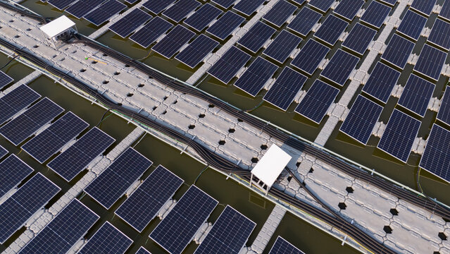 Aerial view of solar panels on water, renewable energy and drone power industry.	