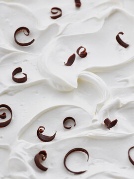 Whipped yogurt with chocolate curls, dessert preparation, bakery display concept