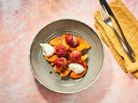 Meatballs with roasted squash and creamy sauce, cozy dinner recipe, comfort food in family dining