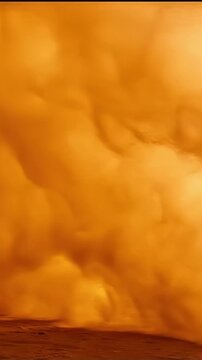 Desert sandstorm blowing dust wave slow motion, wall of golden-orange sand particles moving across frame, elemental desert footage, dramatic atmospheric background for travel climate brand video.
