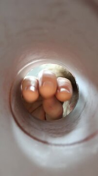 Vertical screen person reaches into a snack tube for another chip highlighting fast food addiction compulsive eating habits cravings and difficulty resisting junk food