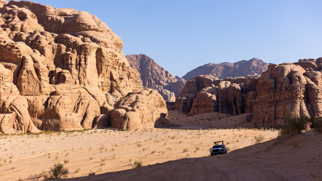 Off-road vehicle exploring the red desert of Wadi Rum, Jordan