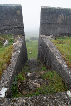 Steps within the ruined Glynn Valley China Clay Works Bodmin Moor Cornwall on a foggy day.