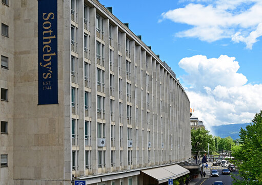 Geneva, Switzerland, Europe - 05.2026 : 5 star  Mandarin Oriental Geneva hotel on the shore of Rhone river, Sotheby's auction house banner on the side wall of the hotel, Quai Turrettini 