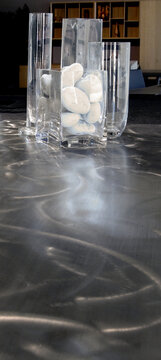Still life of two clear glass vases with white stones inside