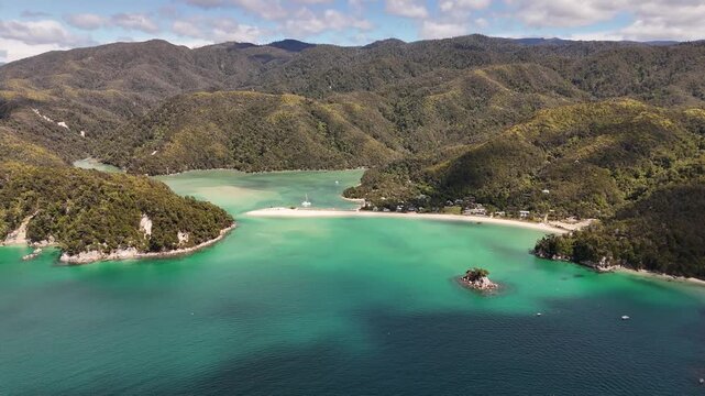 High angle aerial view of Torrent Bay village and its iconic golden sandspit in Abel Tasman National Park.