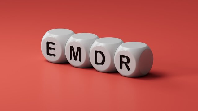 The text EMDR word Eye Movement Desensitization is written on notepad . Medical concept.close up of wooden dice,Business Concept.3D rendering.