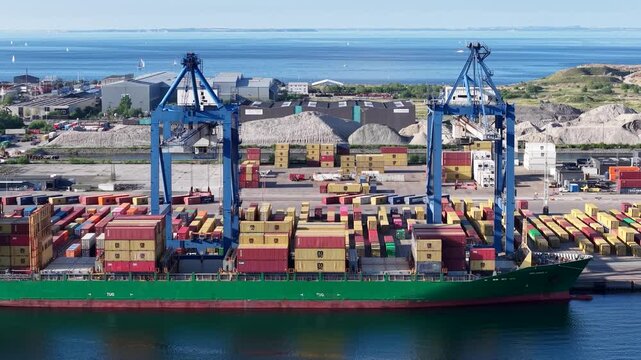 Aerial footage of container ship docked at port, Copenhagen city, Denmark