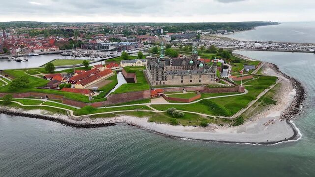 Aerial footage of Kronborg Castle landmark over moat and sea, Helsingor, Denmark