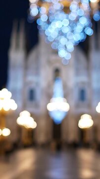 A Beautifully Festive Scene Showcasing a Glowing Chandelier Surrounded by Colorful Lights and Architectural Splendor on a Nighttime Plaza