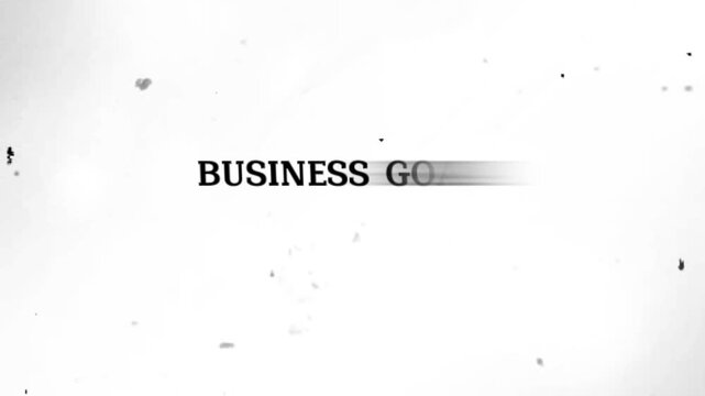 Blurry black text on a white background with speckles and dots around