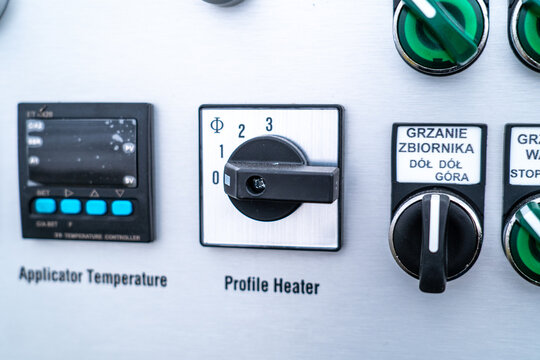 Industrial control panel featuring temperature controller, switches, and profile heater dial