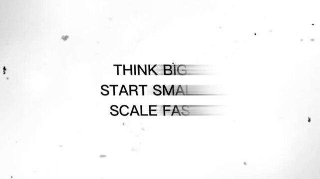 Blurry gray text on white background with speckles