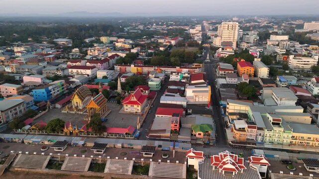 Birds-eye view of the Mekong River international border at dawn, showing the peaceful town of Mukdahan waking up
