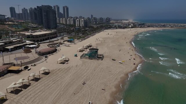 4K Slow Motion Continuation Orbit Drone Around Lifeguard Tower, HaKeshet Beach Ashdod Israel, Sea and City Skyline View