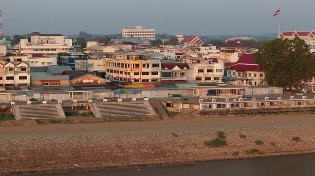 Birds-eye view of the Mekong River international border at dawn, showing the peaceful town of Mukdahan waking up