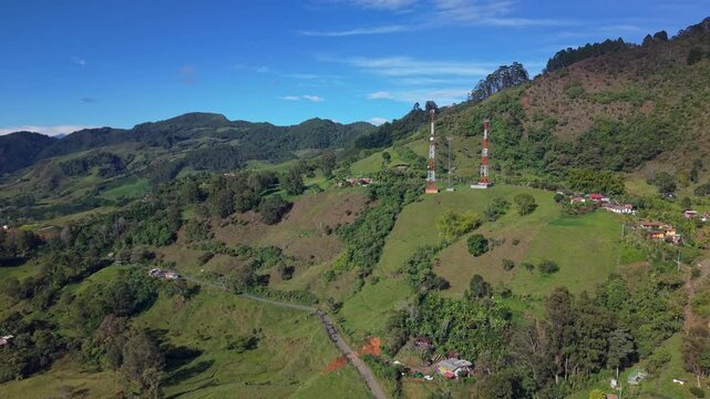 Aerial view of lush green hills and rural landscape near Jerico, Colombia on sunny day
