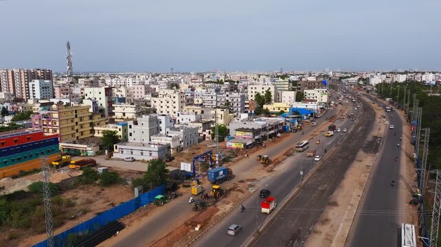 National highway 65 with moving vehicles, residential buildings, apartments and Mobile signal tower at Patancheruvu, hyderabad, telangana, india. day time, crane shot, drone shot, 4k.