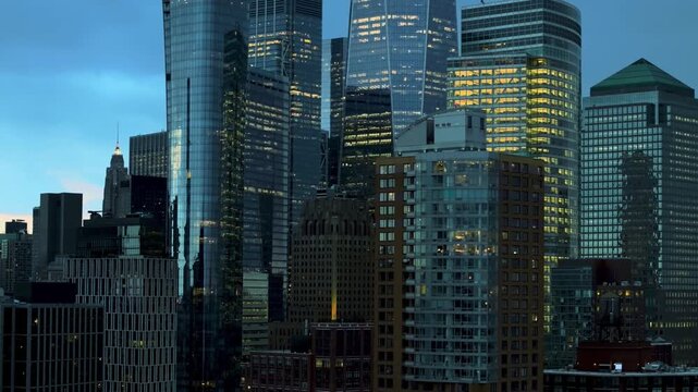 A cinematic slow-moving drone shot capturing close-up views of New York City's towering skyscrapers. The camera glides smoothly past impressive high-rise buildings, showcasing intricate architectural