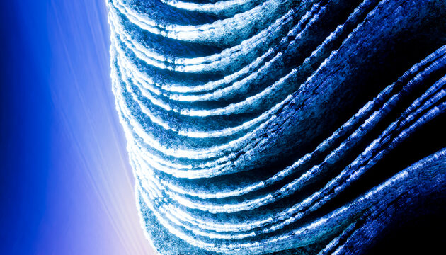 Curved modern architectural facade with glowing lines against a vibrant blue sky.