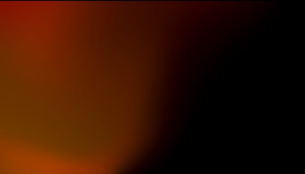 Blurred abstract image with gradient blend of warm red, orange, and black colors.