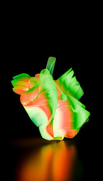 Abstract green and orange illuminated light sculpture against black background