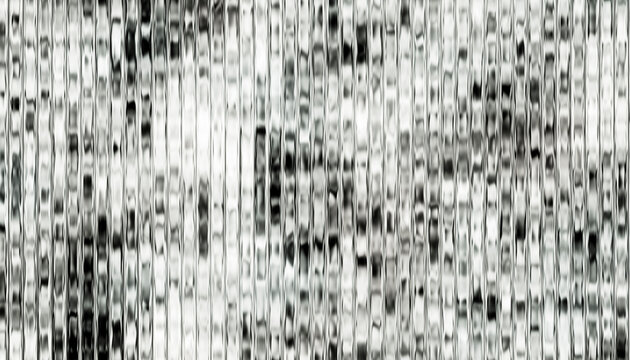 Abstract textured wall with small square tiles in a grayscale pattern.