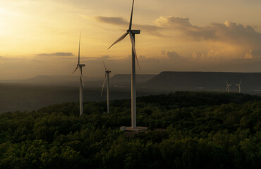 Obraz premium Wind energy. Wind power. Sustainable, renewable energy. Wind turbines generate electricity. Windmill farm on a mountain with sunset sky. Green technology. Renewable resource. Sustainable development.