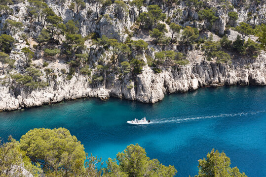 Boat Entering Calanque de Port Pin Along French Riviera During Summer in France