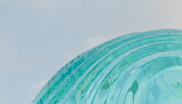 Abstract view of light blue spiraling glass with a soft sky backdrop.