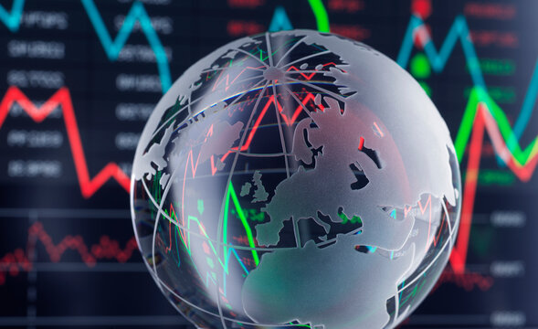Glass globe in front of fluctuating stock market graph with red and green lines.