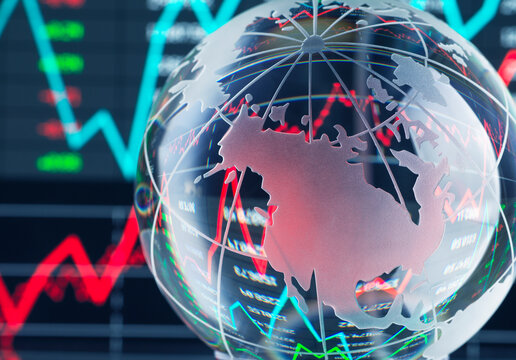 Transparent globe with stock market charts in the background depicting economic trends.