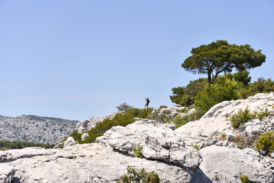 Hiker Amid French Riviera Mountains Along the Trail to Calanque d&rsquo;En-Vau During Summer in France