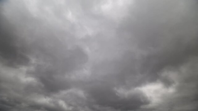 Dramatic stormy clouds. Fastmoving dark clouds with lighting. Cinematic scene of storm clouds and contrasts. Rapid sky changes with brooding clouds and occasional light bursts