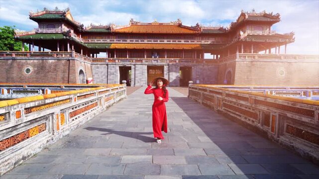 Elegant Girl in Ao Dai dress Entering Imperial Citadel Hue: Graceful Presence Amidst Hue's Royal Legacy, co do Hue, cung dinh Hue, Vietnam.