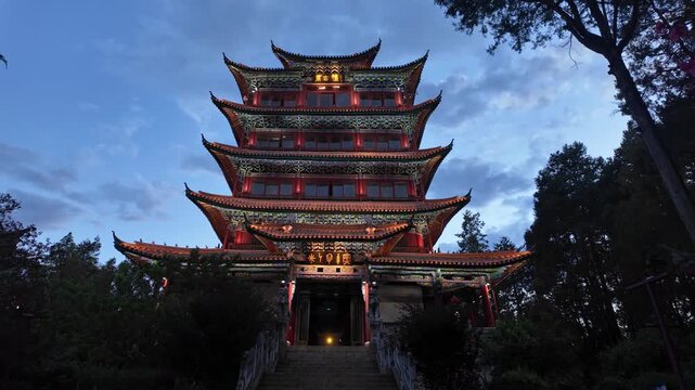 Lijiang, China : Tilt down footage of Chinese pagoda at the top of the Shizi Mountain Wangulou Scenic Area in Lijiang at twilight in Yunnan province in China
